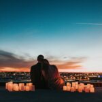 People beside glowing candles at night; illustrative stock photograph, not Love Is Blind participants.