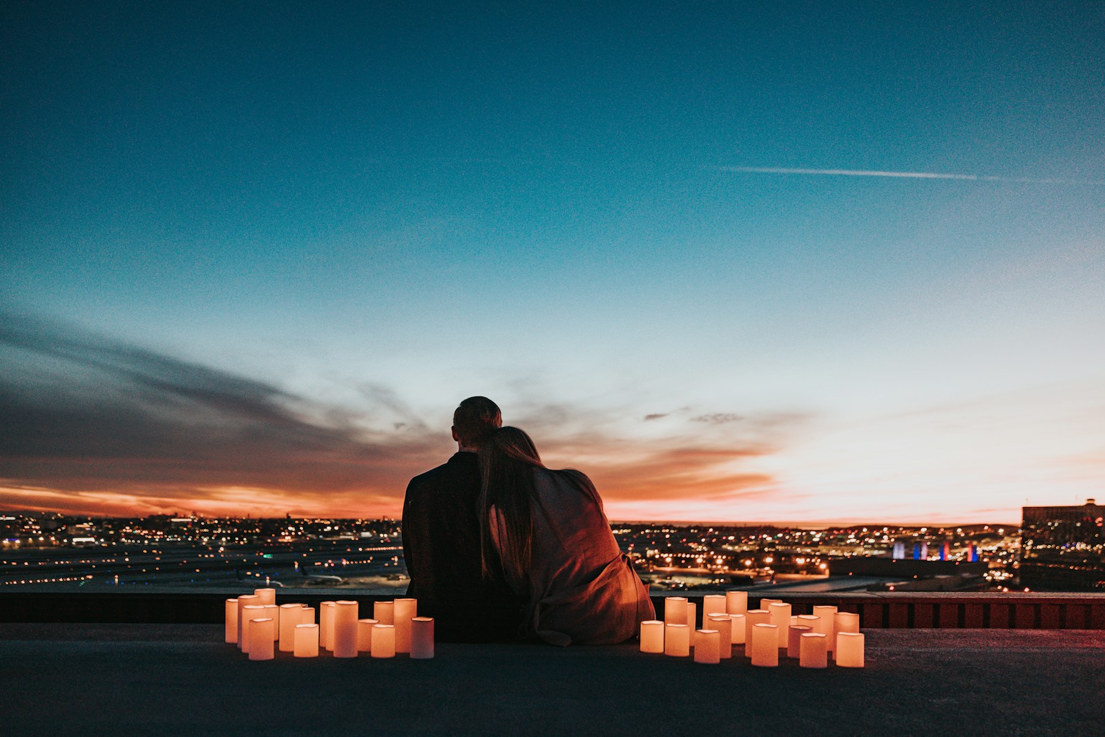 People beside glowing candles at night; illustrative stock photograph, not Love Is Blind participants.