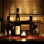 Wine glass and bottle on a dinner table; illustrative stock photograph, not a Nobody Wants This scene.