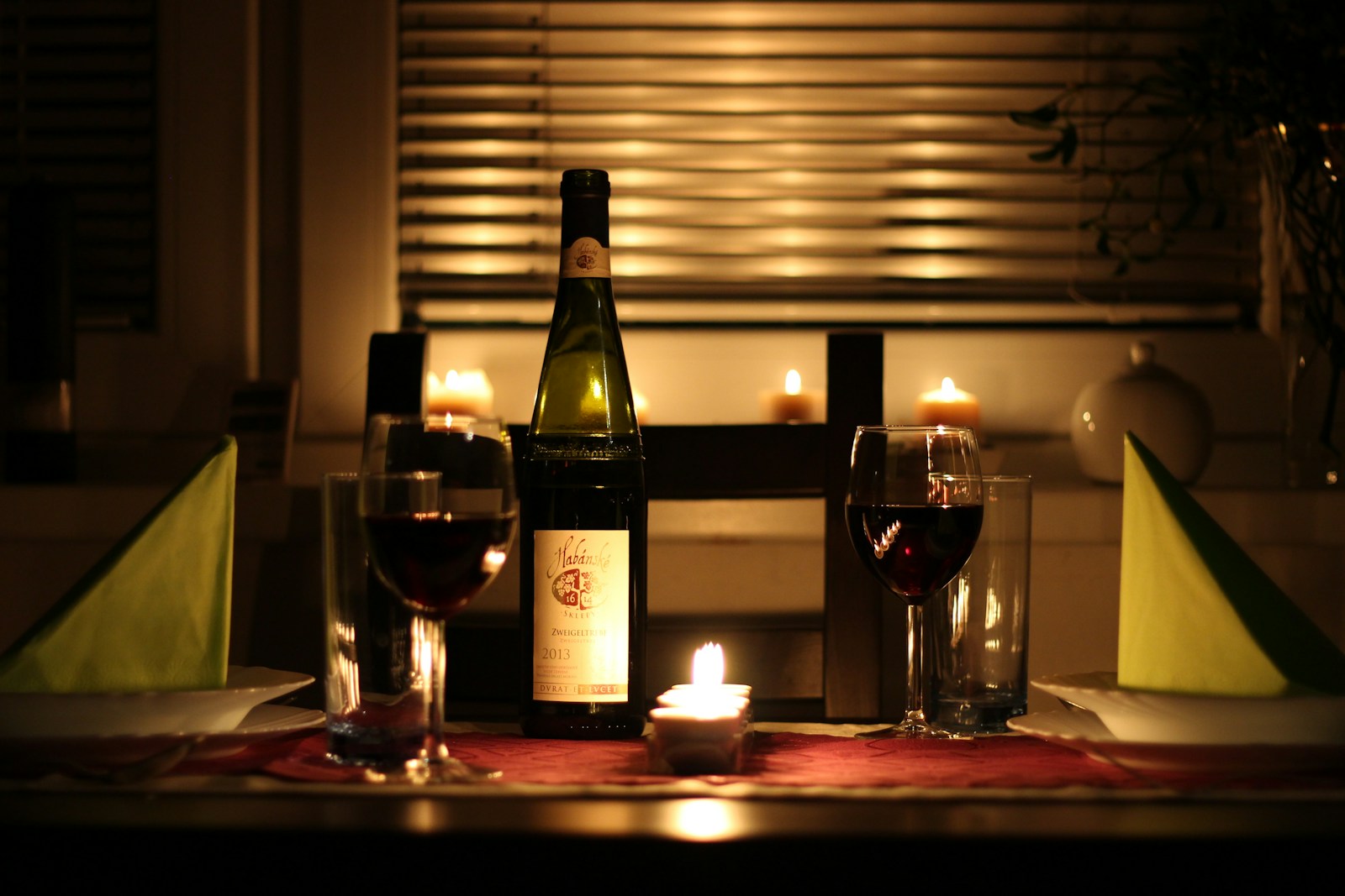 Wine glass and bottle on a dinner table; illustrative stock photograph, not a Nobody Wants This scene.
